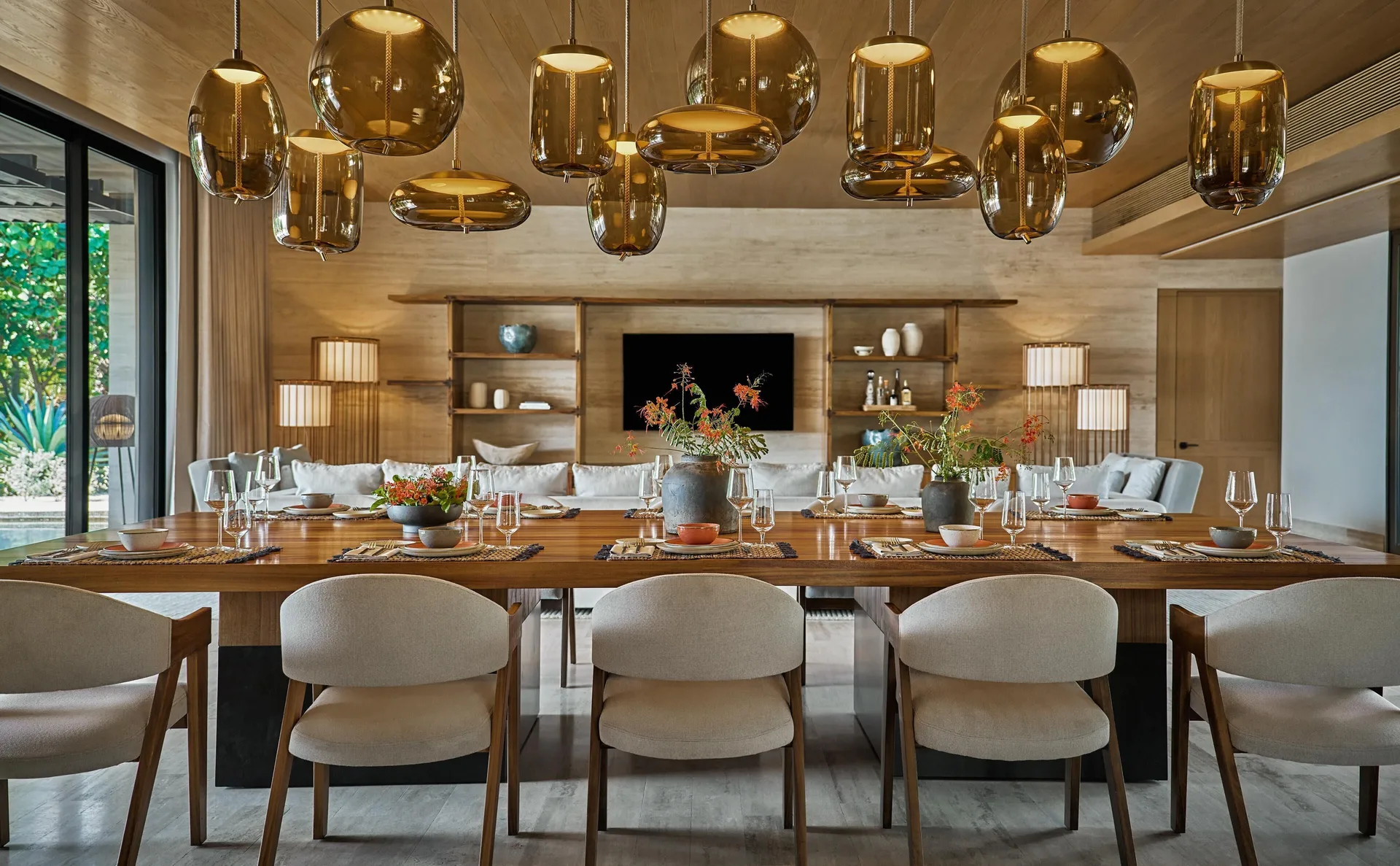 Casa Dolphin dining table at Montage Los Cabos set beneath amber pendant lights.