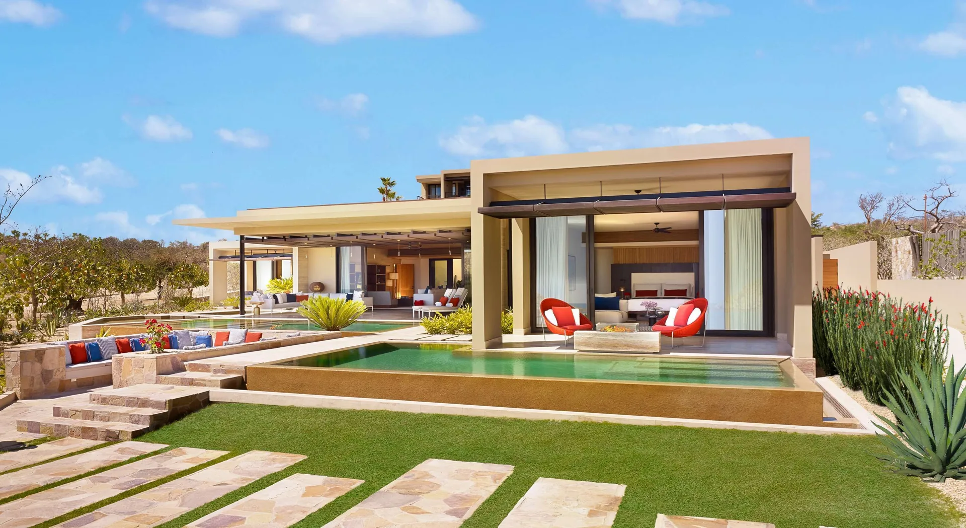 Casa Dolphin at Montage Los Cabos with pool, lawn, outdoor seating, and bedroom pavilion in daylight.