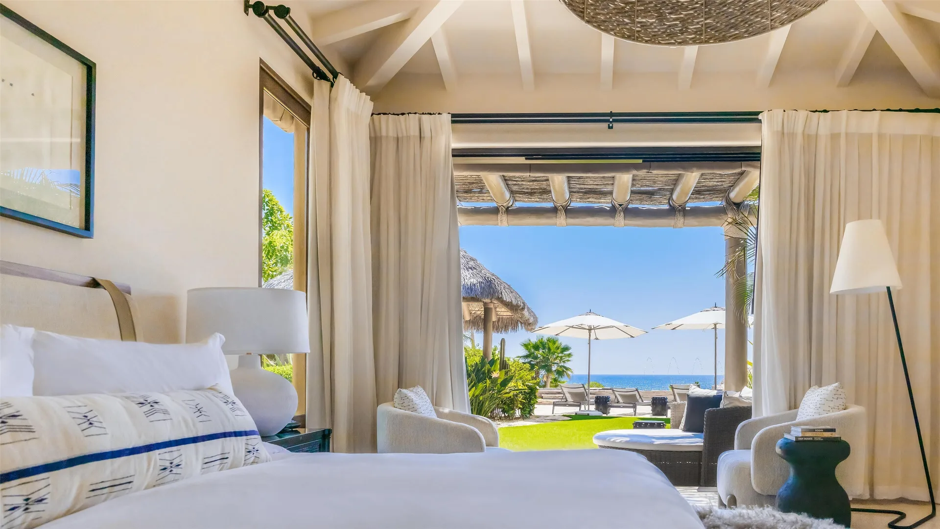 Casa Santa Maria bedroom at Montage Los Cabos with bed, sitting area, terrace, and ocean beyond.