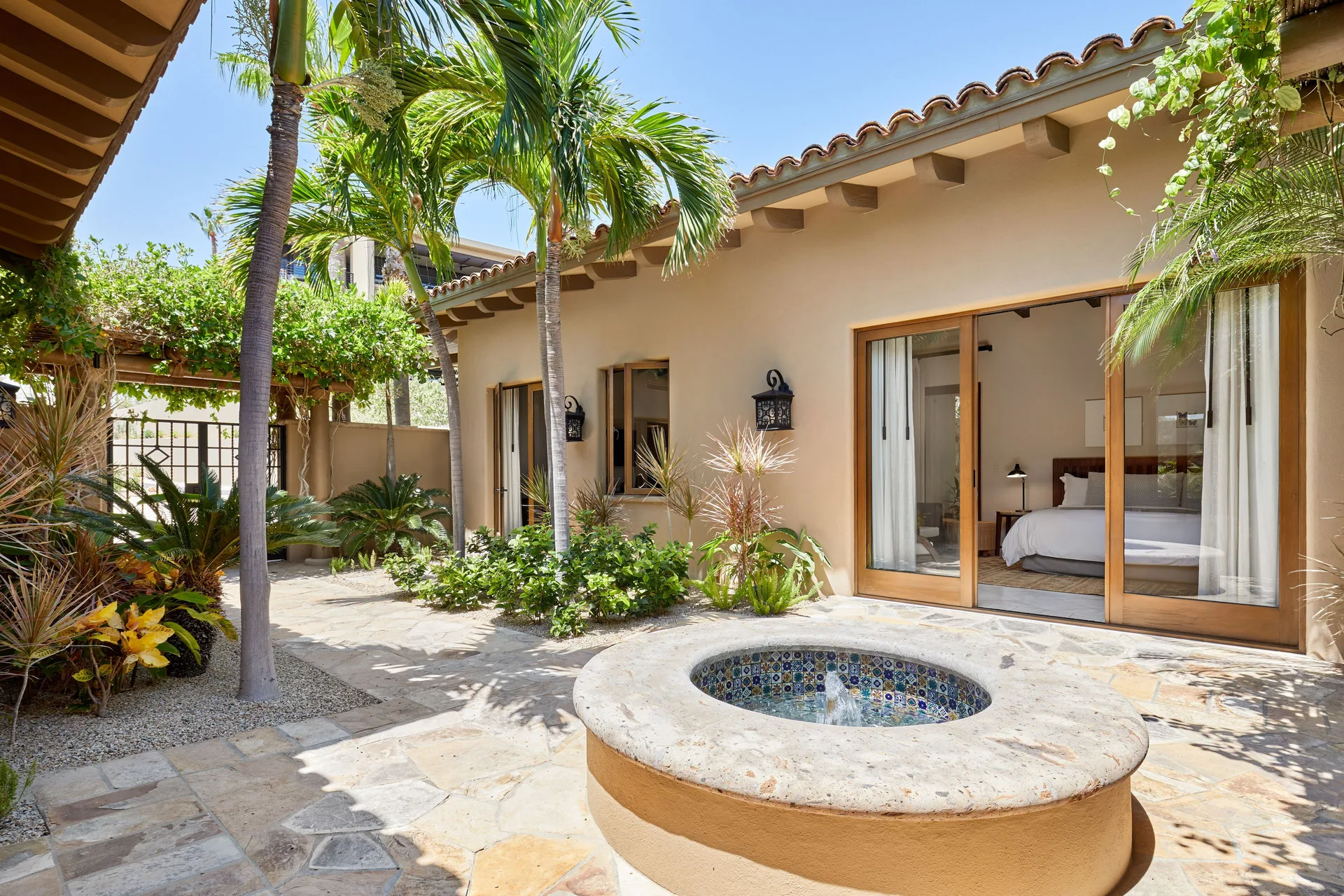 Casa Santa Maria courtyard with fountain and bedroom doors at Montage Los Cabos.
