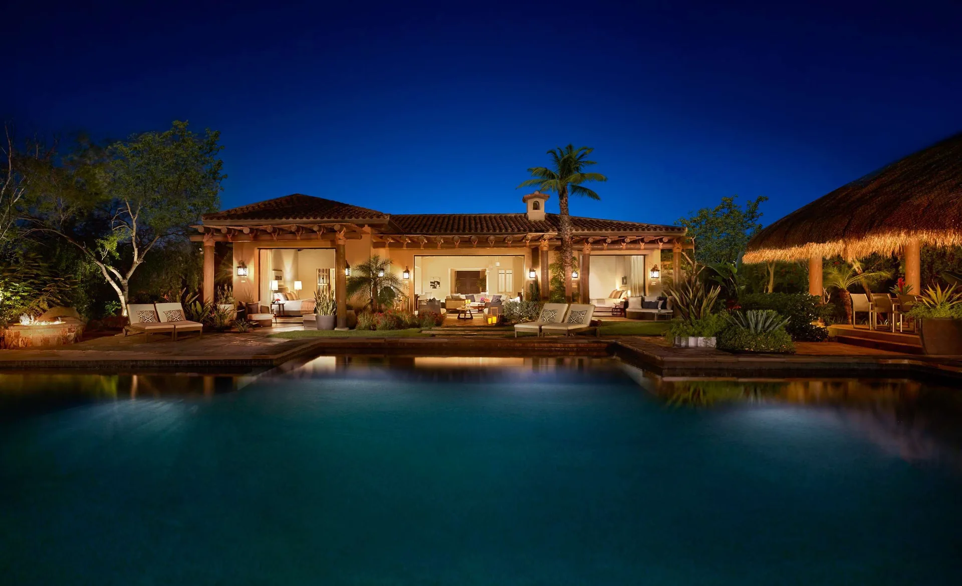 Casa Santa Maria exterior at Montage Los Cabos with illuminated patio and pool at night.