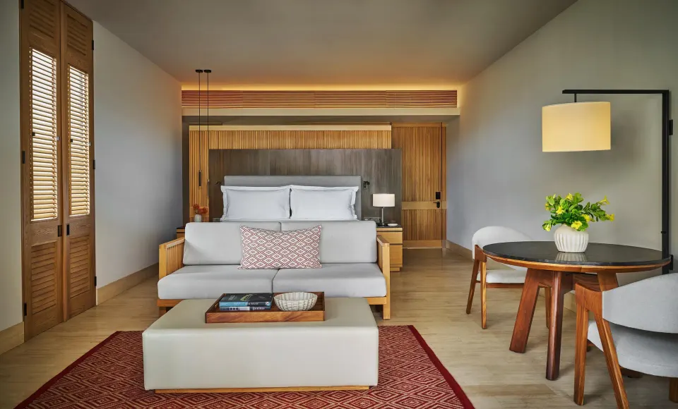 Coastal View Accessible Room with king bed, sofa, and dining table at Montage Los Cabos.