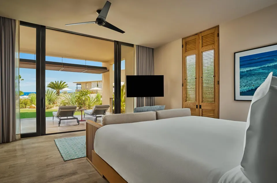 Deluxe Ocean View One Bedroom Suite king bedroom opening to patio at Montage Los Cabos.