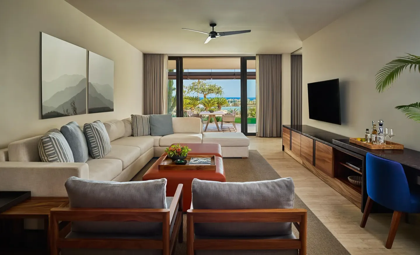 Deluxe Ocean View One Bedroom Suite lounge with ocean-facing doors at Montage Los Cabos.