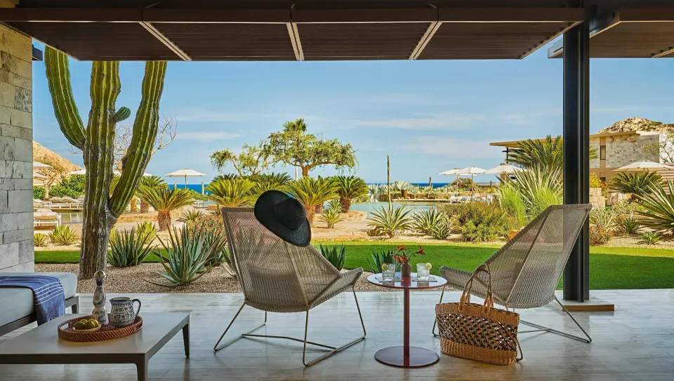Deluxe Ocean View One Bedroom Suite terrace with lounge chairs at Montage Los Cabos.