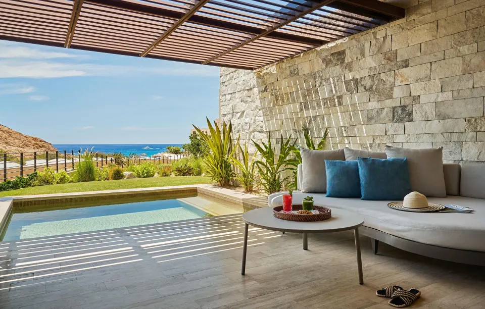Deluxe Ocean View with Pool terrace at Montage Los Cabos with shaded sofa, plunge pool and blue ocean.