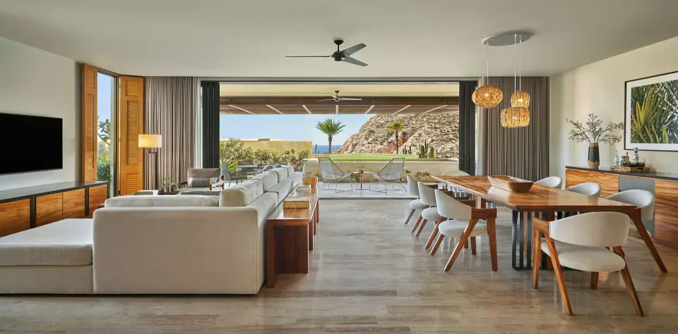 Living and dining room opening to the terrace at Montage Los Cabos.