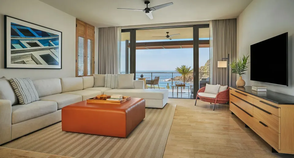 Guest room living area with balcony ocean view at Montage Los Cabos.