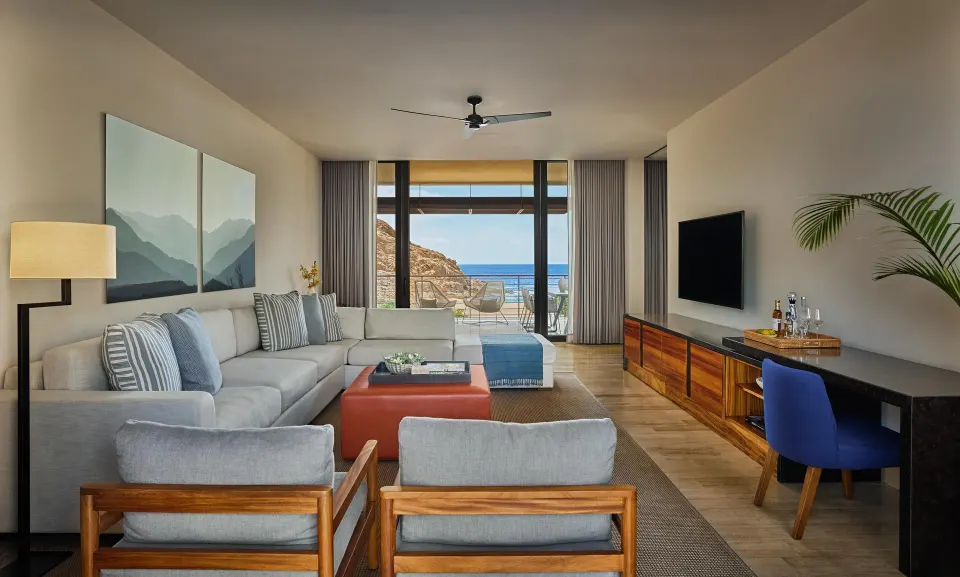 Ocean View One Bedroom Suite living area with sofa and ocean-facing terrace at Montage Los Cabos.