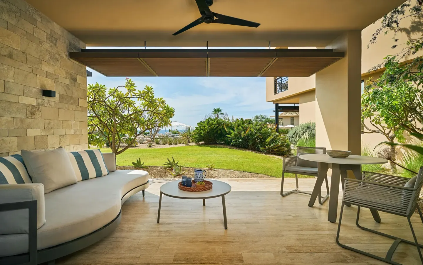 Ocean View Room terrace with lounge seating and garden at Montage Los Cabos.
