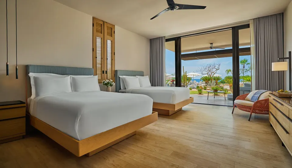 Ocean View Two Bedroom Suite bedroom with two beds and terrace at Montage Los Cabos.