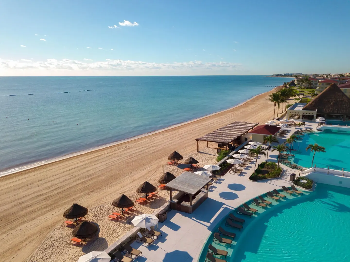 Beach, palapas, and oceanfront pools at Moon Palace Cancun.