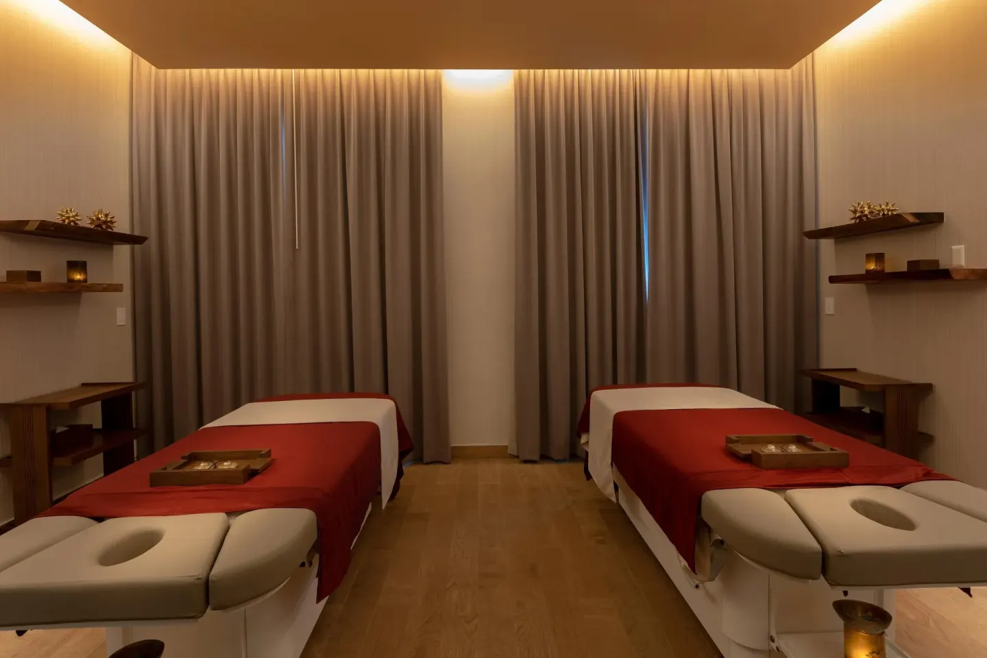 Two massage treatment tables with red linens at Moon Palace Cancun.