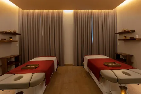 Two massage treatment tables with red linens at Moon Palace Cancun.