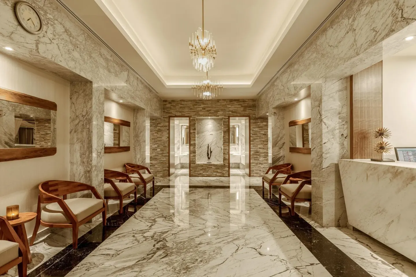 Marble spa reception lounge with wood chairs at Moon Palace Cancun.