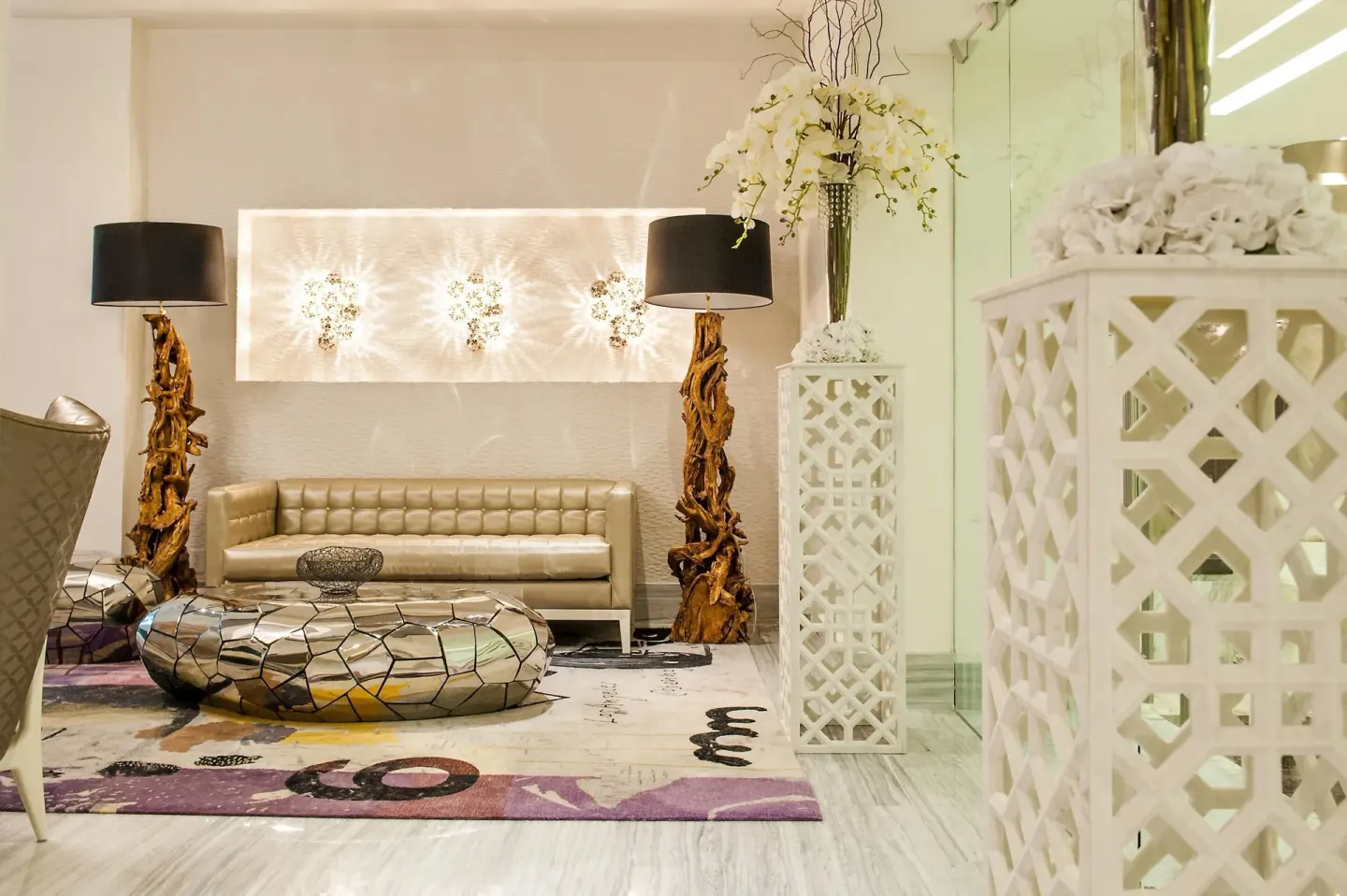 Modern lobby seating with sculptural lamps and floral decor at Moon Palace Cancun.