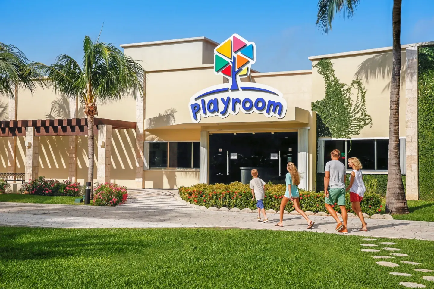 A family walks toward the Playroom entrance at Moon Palace Cancun.