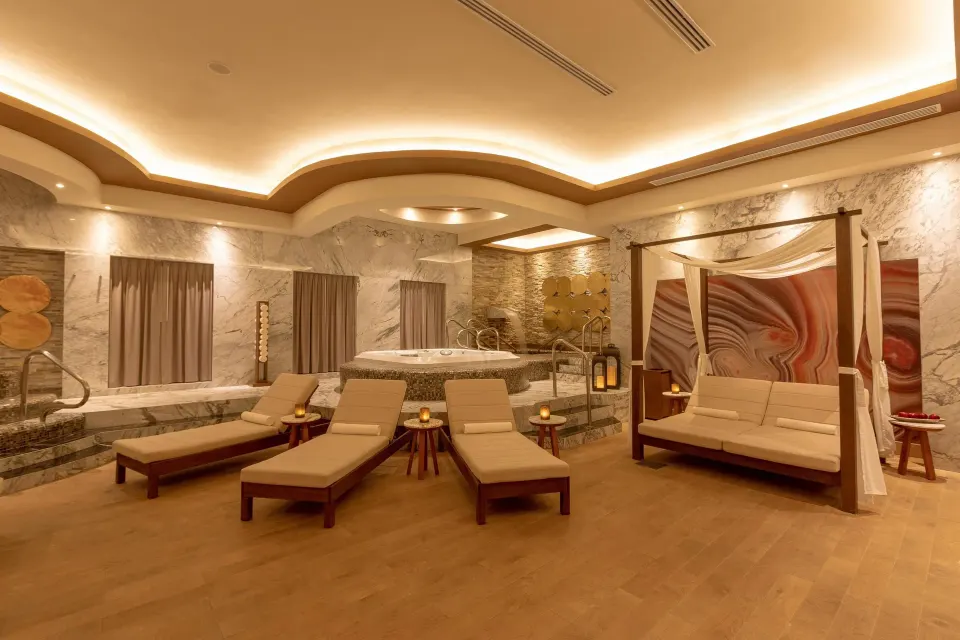 Spa lounge with chaise beds, whirlpool and canopy sofa at Moon Palace Cancun.