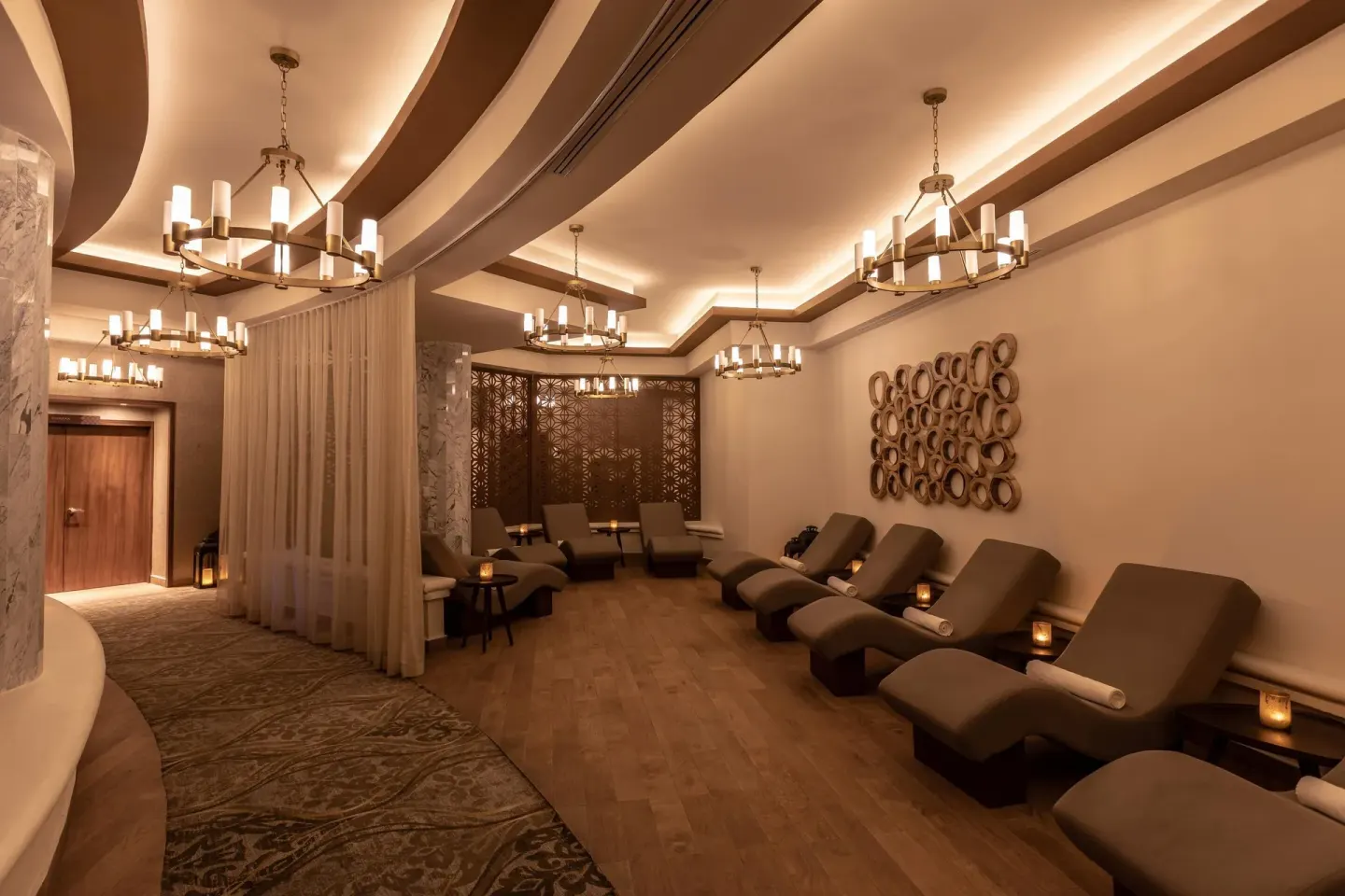 Spa relaxation room with chaise lounges and chandeliers at Moon Palace Cancun.