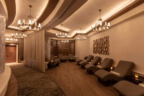 Spa relaxation room with chaise lounges and chandeliers at Moon Palace Cancun.
