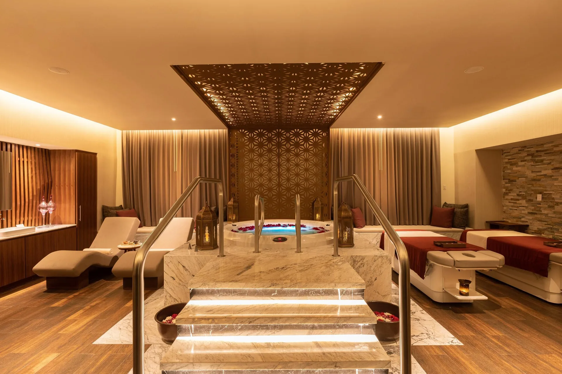 Spa treatment suite with whirlpool, loungers and massage beds at Moon Palace Cancun.