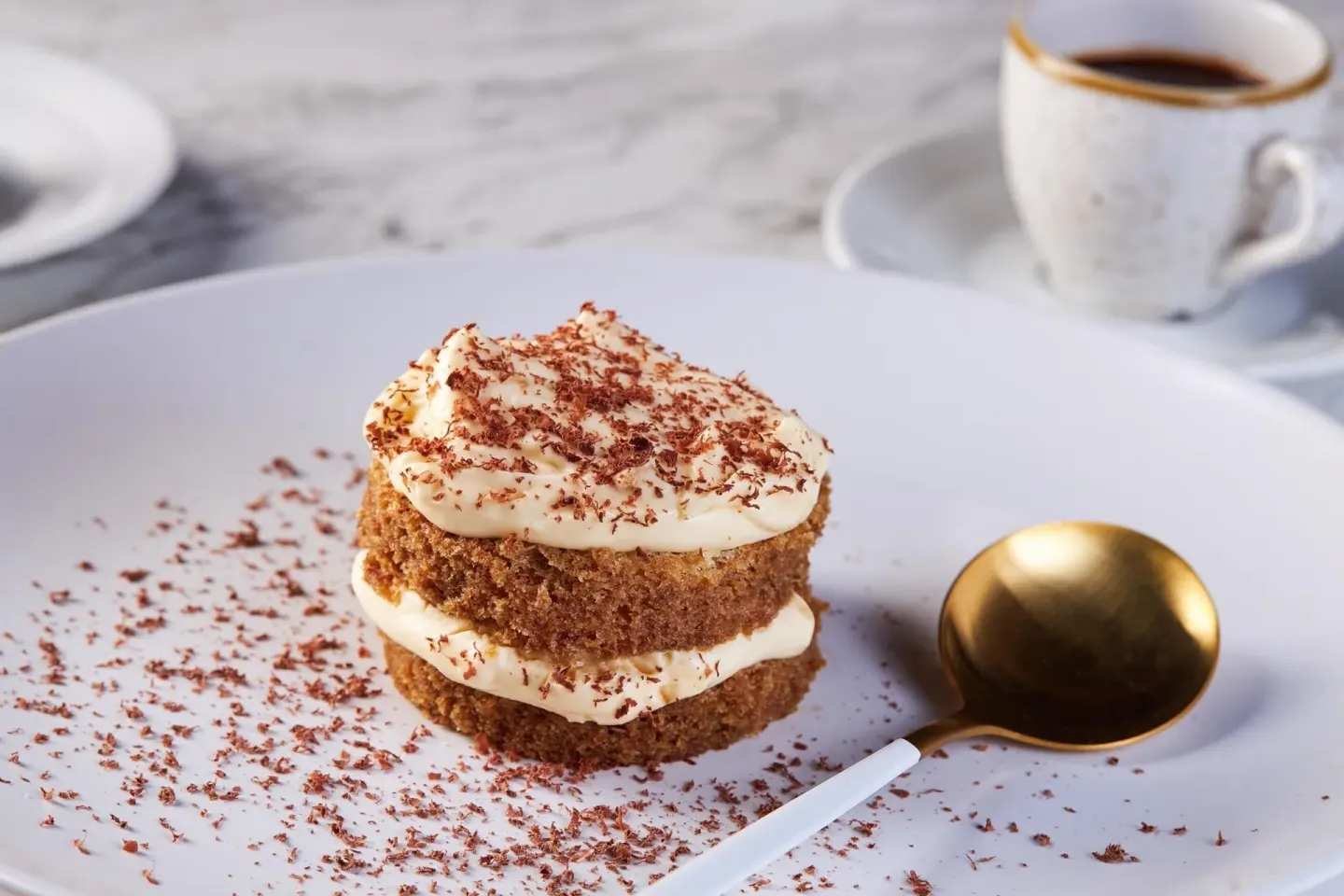 Layered dessert with cream, chocolate shavings, and coffee at Moon Palace Cancun.