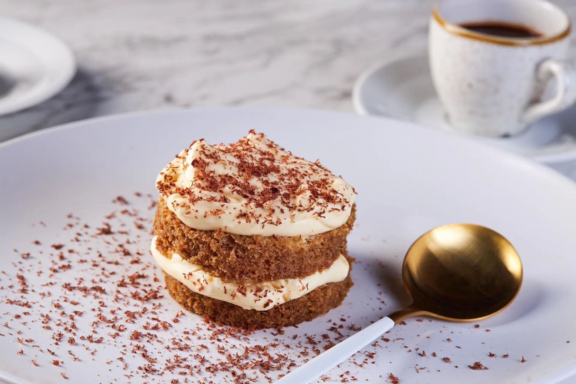 Layered dessert with cream, chocolate shavings, and coffee at Moon Palace Cancun.