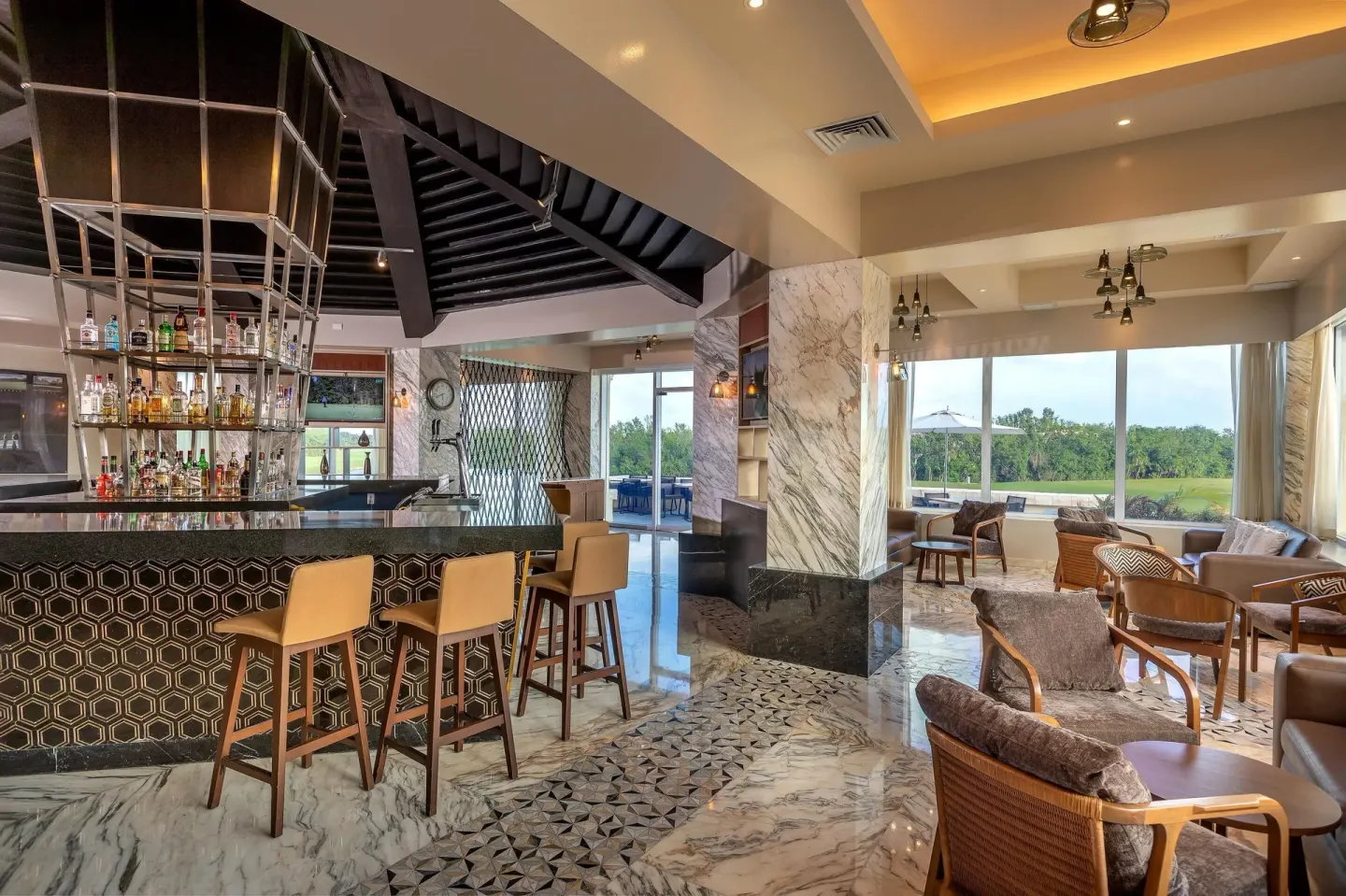 Modern bar lounge with stools and window seating at Moon Palace Cancun.