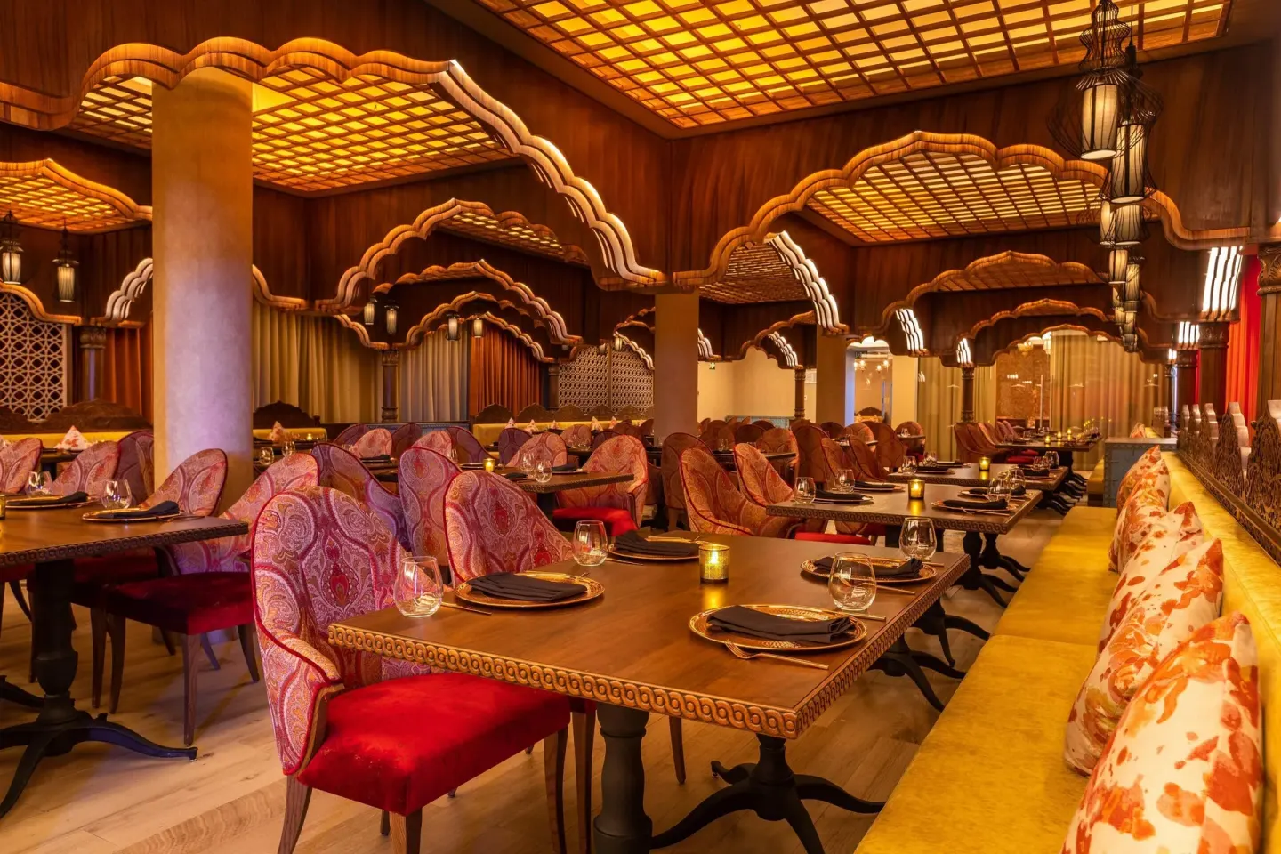 Ornate Indian restaurant dining room with arched wood details at Moon Palace Cancun.