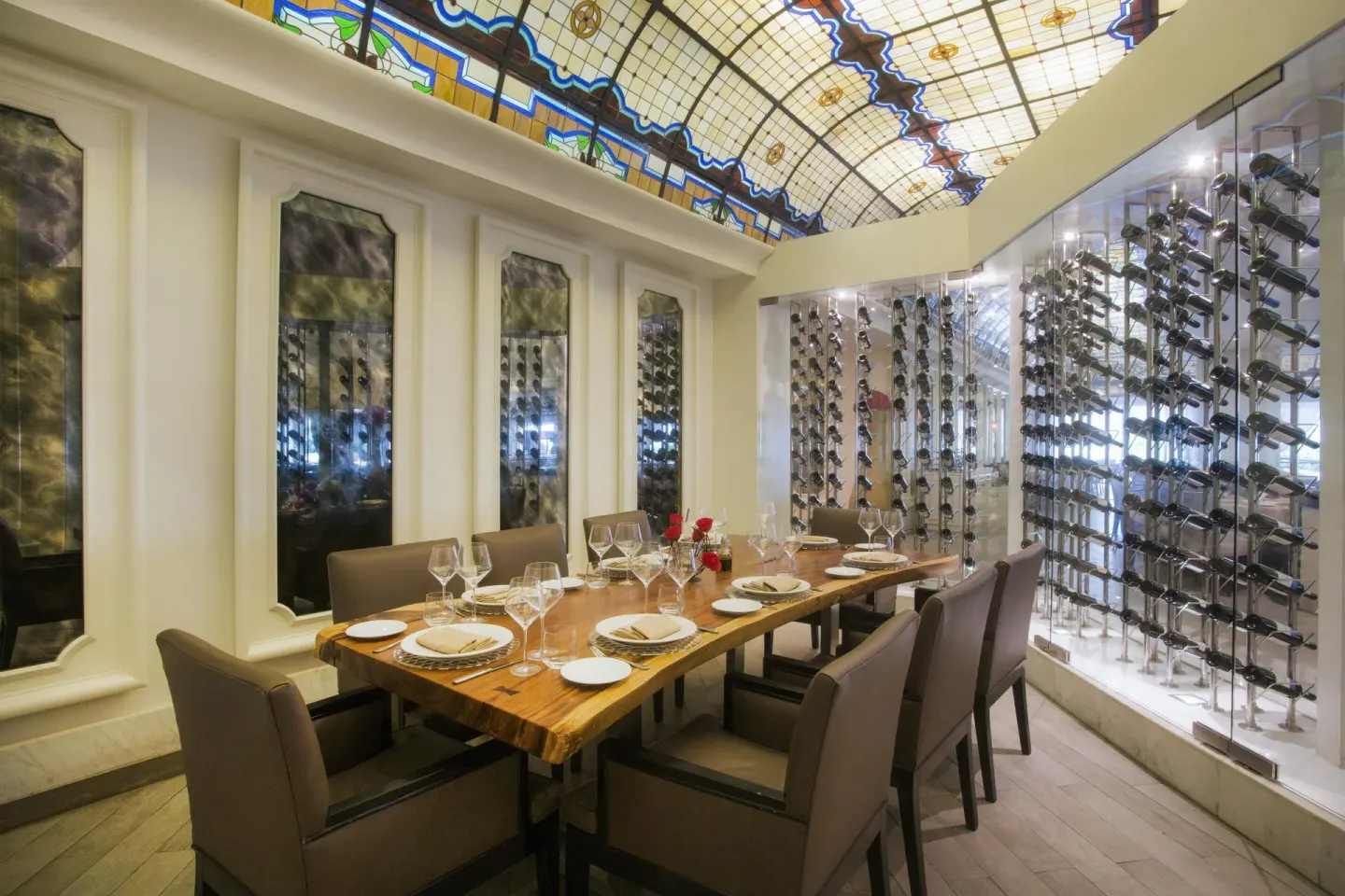 Private dining table beside glass wine racks at Moon Palace Cancun.