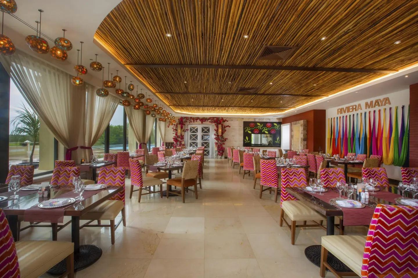Riviera Maya restaurant dining room with colorful chairs at Moon Palace Cancun.