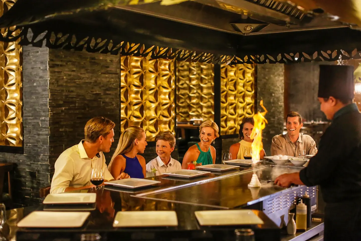 Chef cooks at a teppanyaki grill for diners at Moon Palace Cancun.
