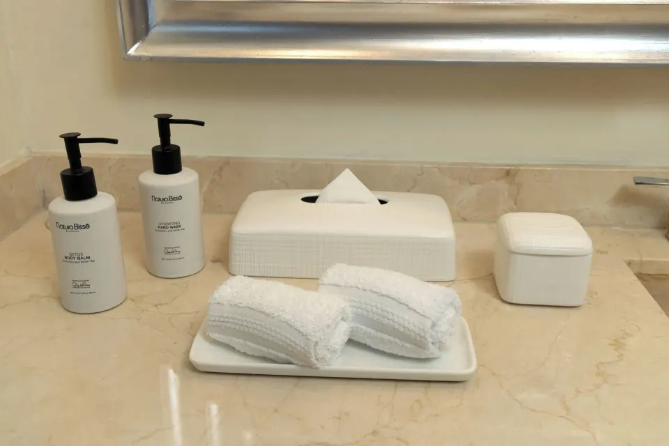 Bathroom counter with towels, tissue box, and bath amenities at Moon Palace Cancun.