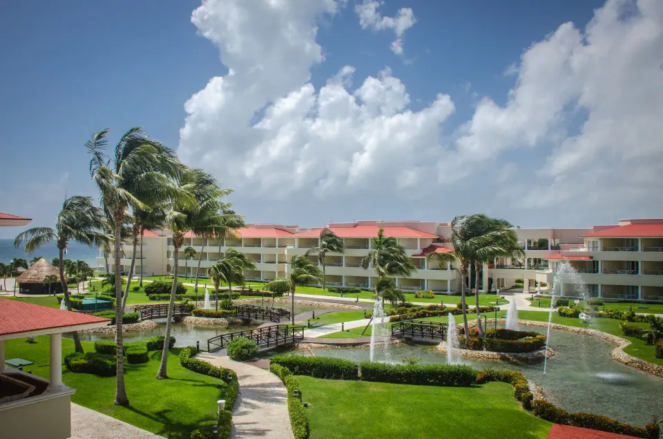 Garden view with ponds, fountains, palms, and room buildings at Moon Palace Cancun.