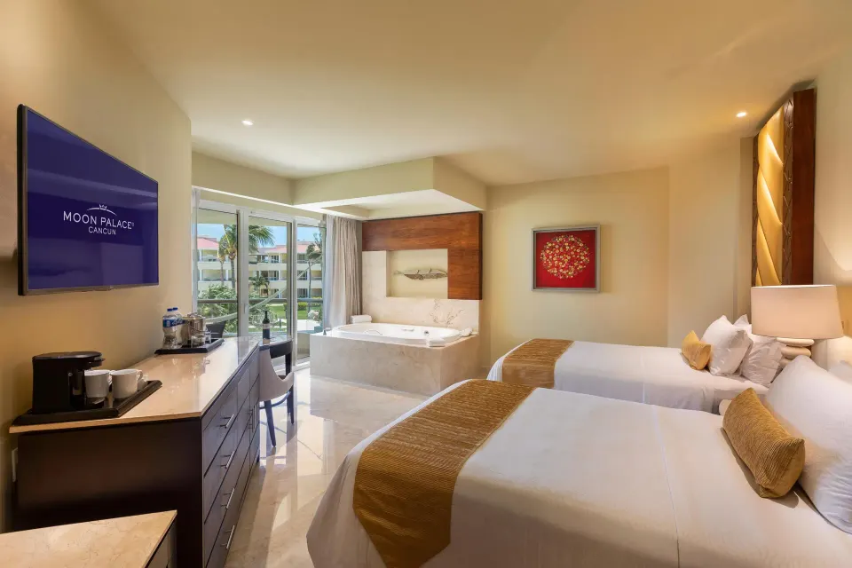 Superior Deluxe Garden View two-bed room with balcony doors at Moon Palace Cancun.