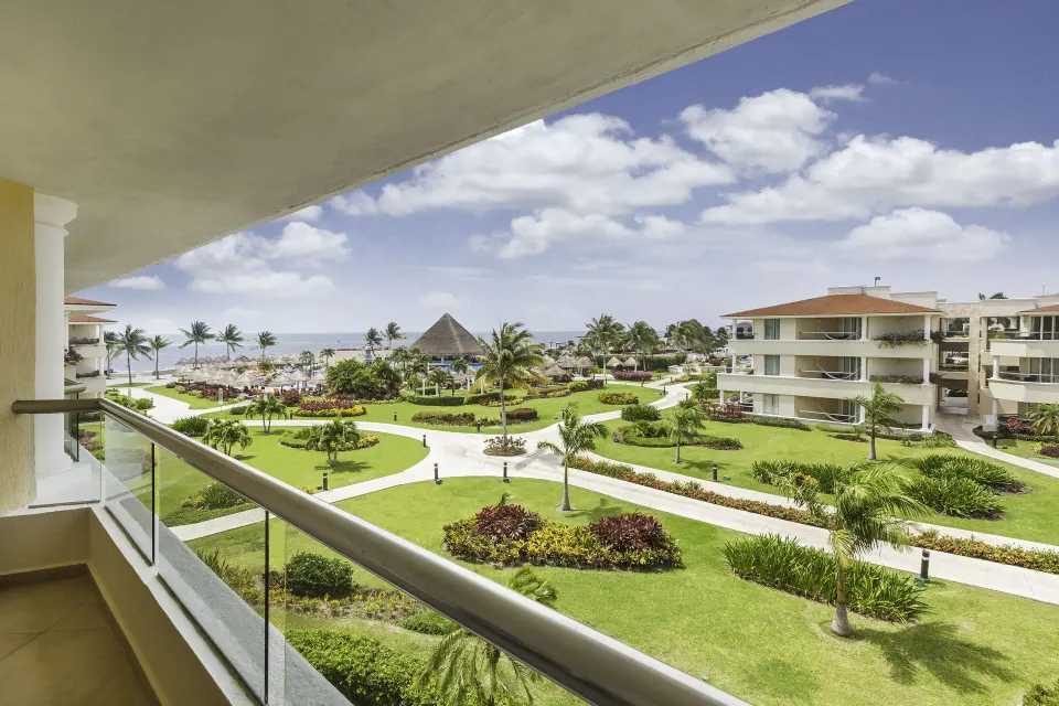 Ocean-view balcony overlooking gardens at Moon Palace Cancun.
