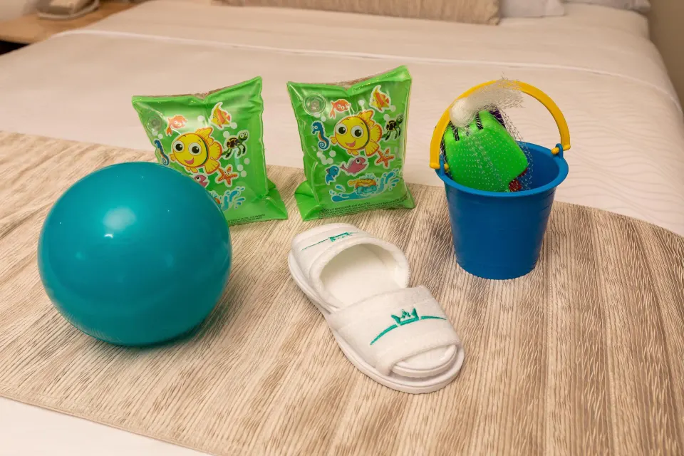 Kids' welcome items on a bed in a Superior Family Deluxe room at Moon Palace Cancun.