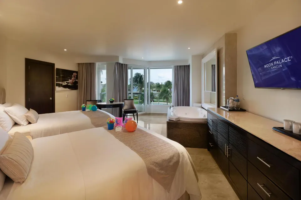 Superior Family Deluxe room with two beds, kids' items and tub at Moon Palace Cancun.