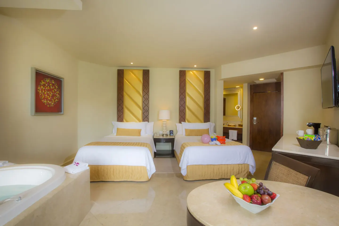 Superior Family Deluxe room with two beds, whirlpool tub and table at Moon Palace Cancun.