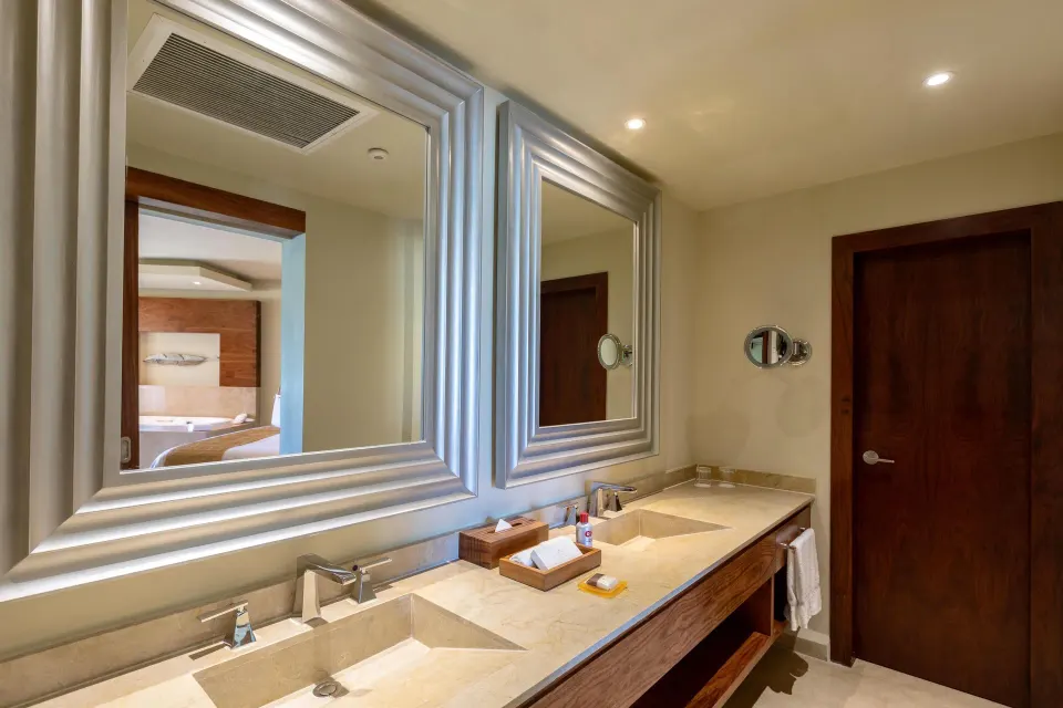 Superior Governor Suite bathroom vanity with double sinks and mirrors at Moon Palace Cancun.