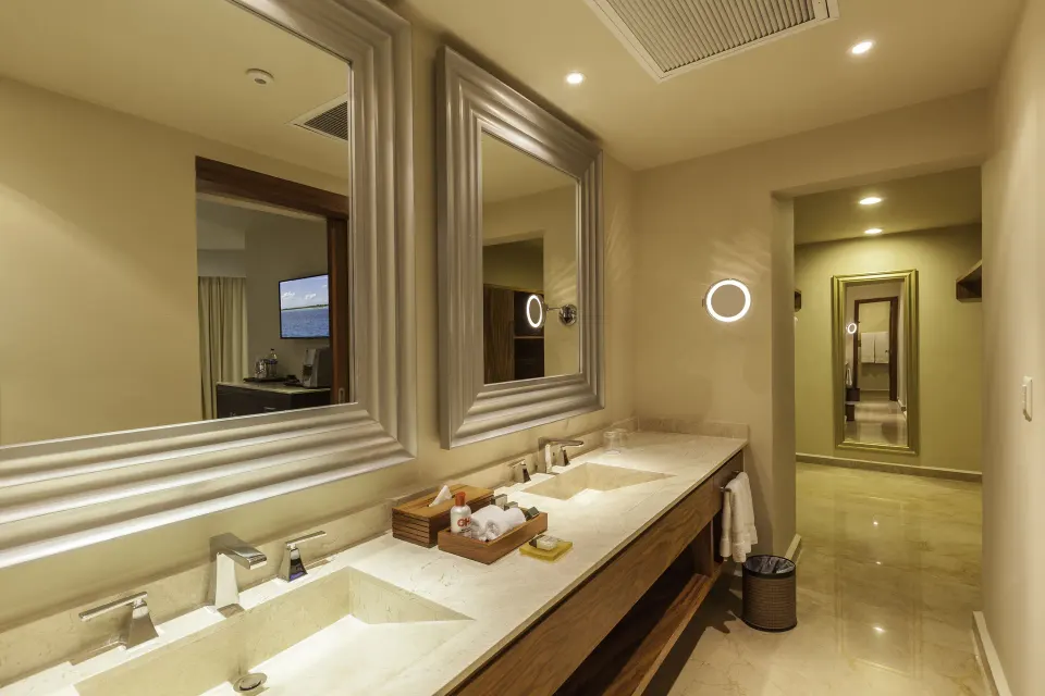 Superior Governor Suite bathroom with double vanity and hallway mirror at Moon Palace Cancun.