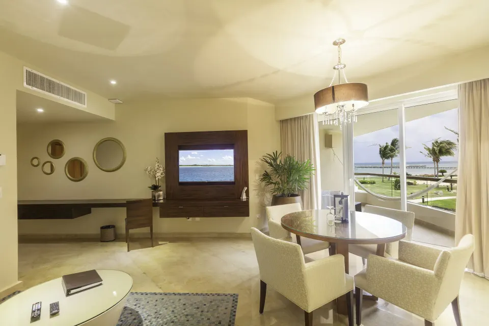 Superior Governor Suite living and dining area with balcony view at Moon Palace Cancun.