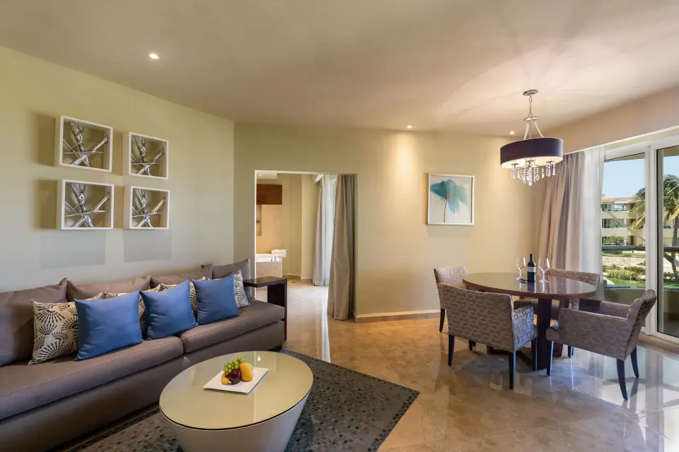 Superior Governor Suite sitting area with sofa and dining table at Moon Palace Cancun.