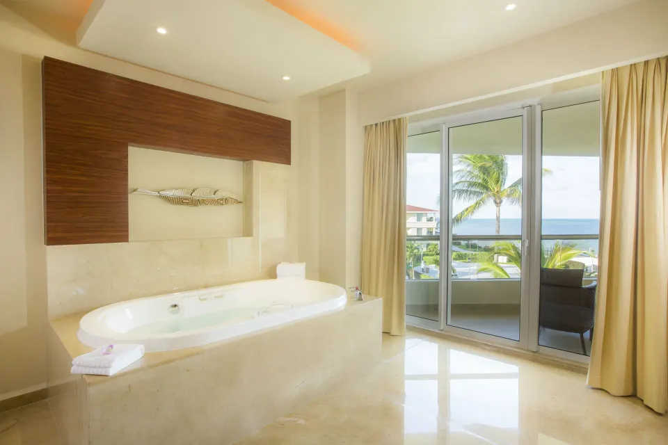 Superior Governor Suite whirlpool tub by balcony doors at Moon Palace Cancun.