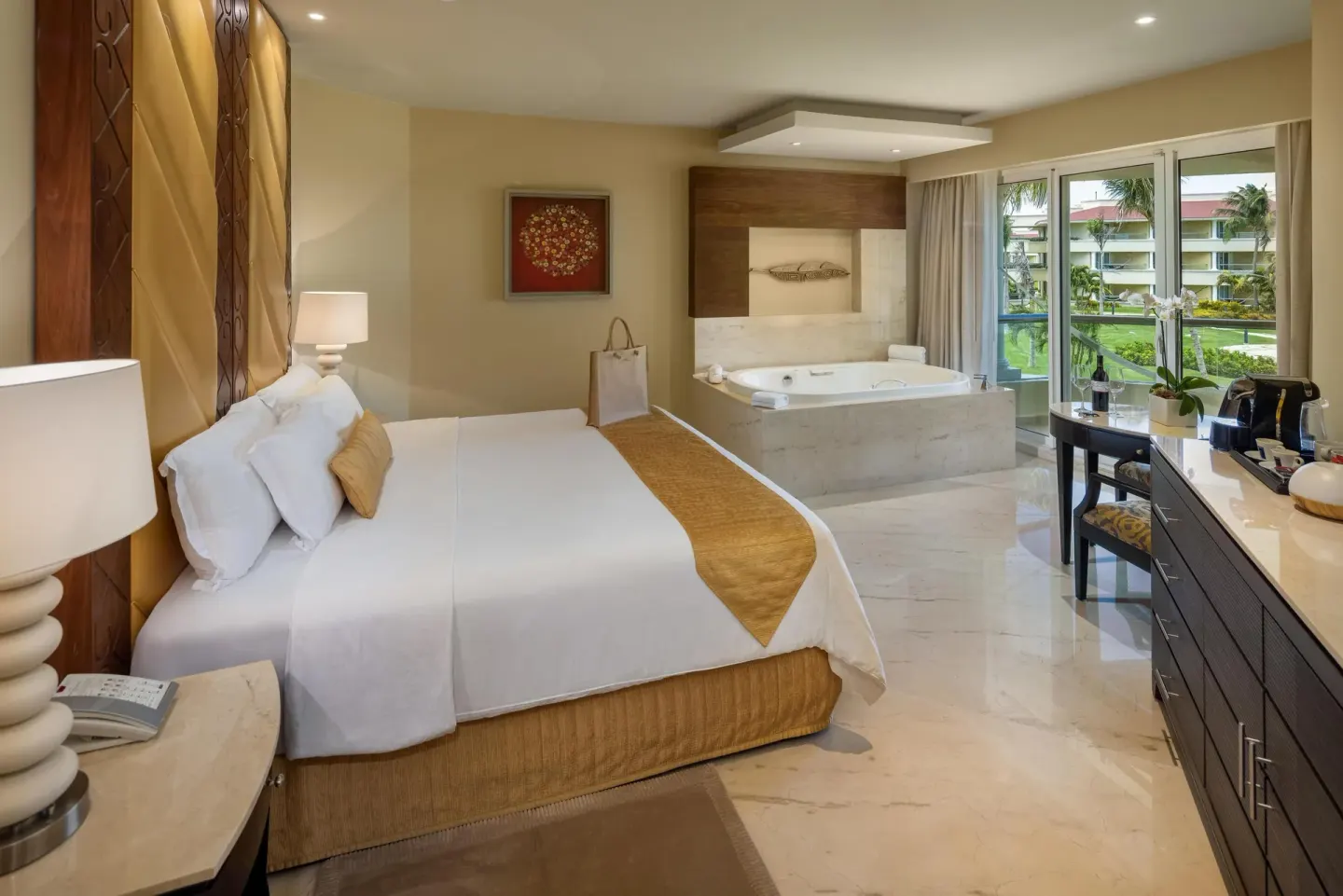 Superior Honeymoon Suite king bed and in-room tub at Moon Palace Cancun.