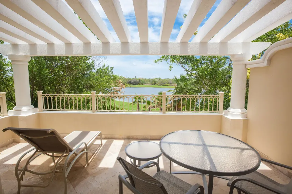 Private terrace with lounge chair and golf course view at Moon Palace Cancun.