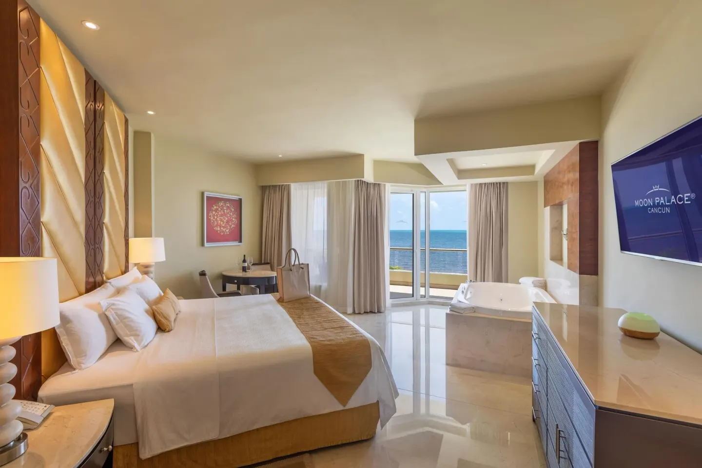 Superior Two Bedroom Presidential Suite bedroom with ocean-facing balcony at Moon Palace Cancun.
