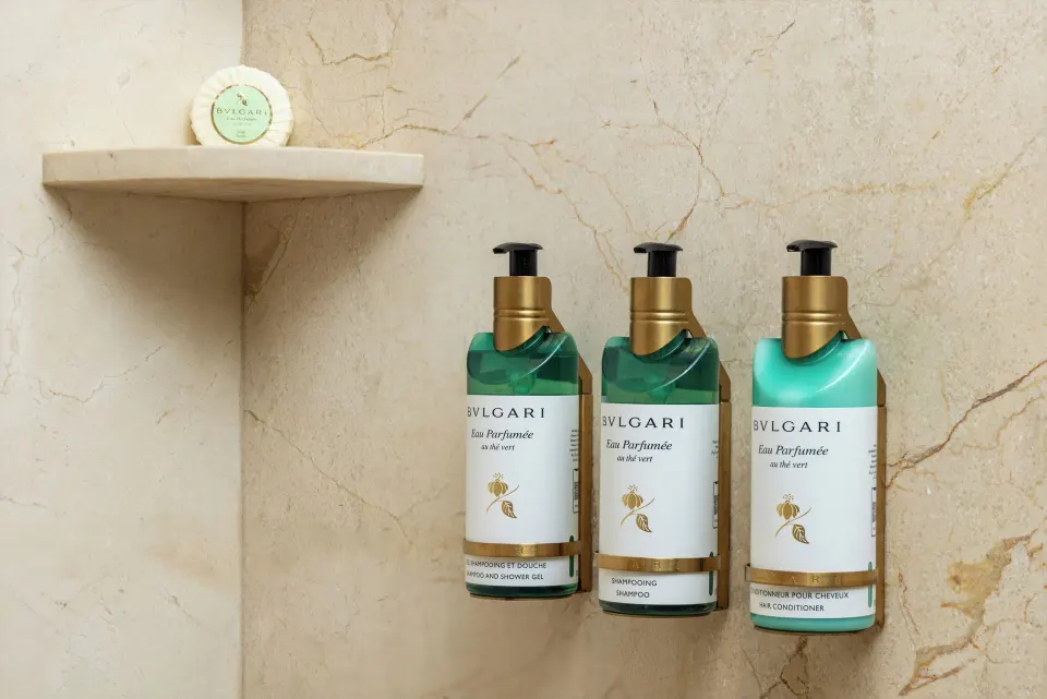 Shower amenities mounted on a stone wall in a suite at Moon Palace Cancun.