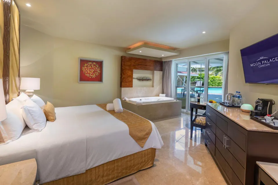 Swim Up Suite king bedroom with whirlpool tub and pool terrace at Moon Palace Cancun.