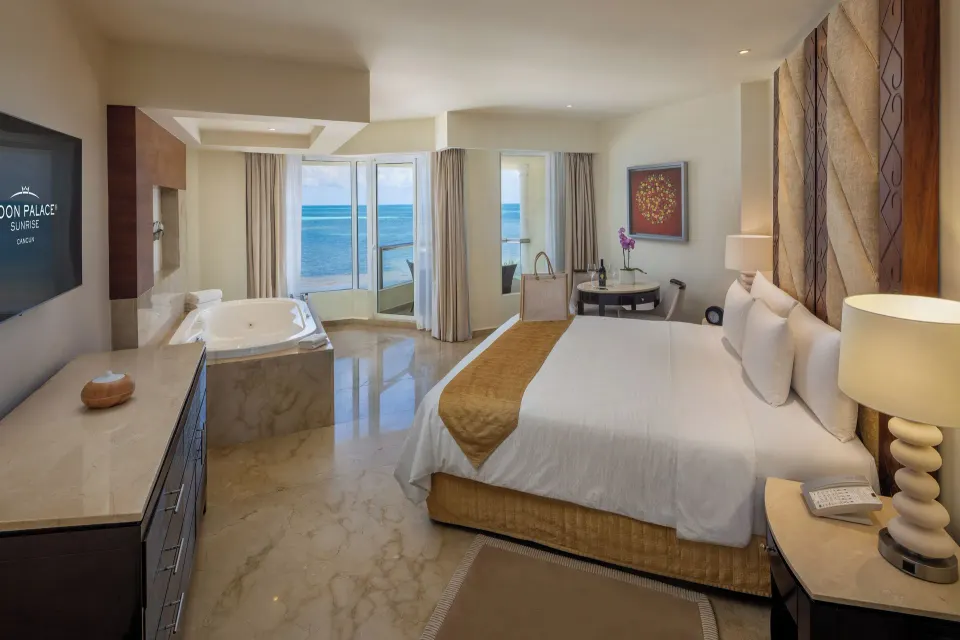 King bedroom with whirlpool tub and ocean-facing windows at Moon Palace Cancun.